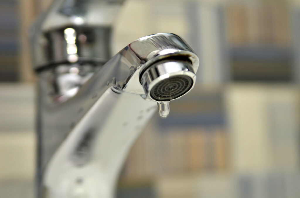 Bathroom tap leaking water drops